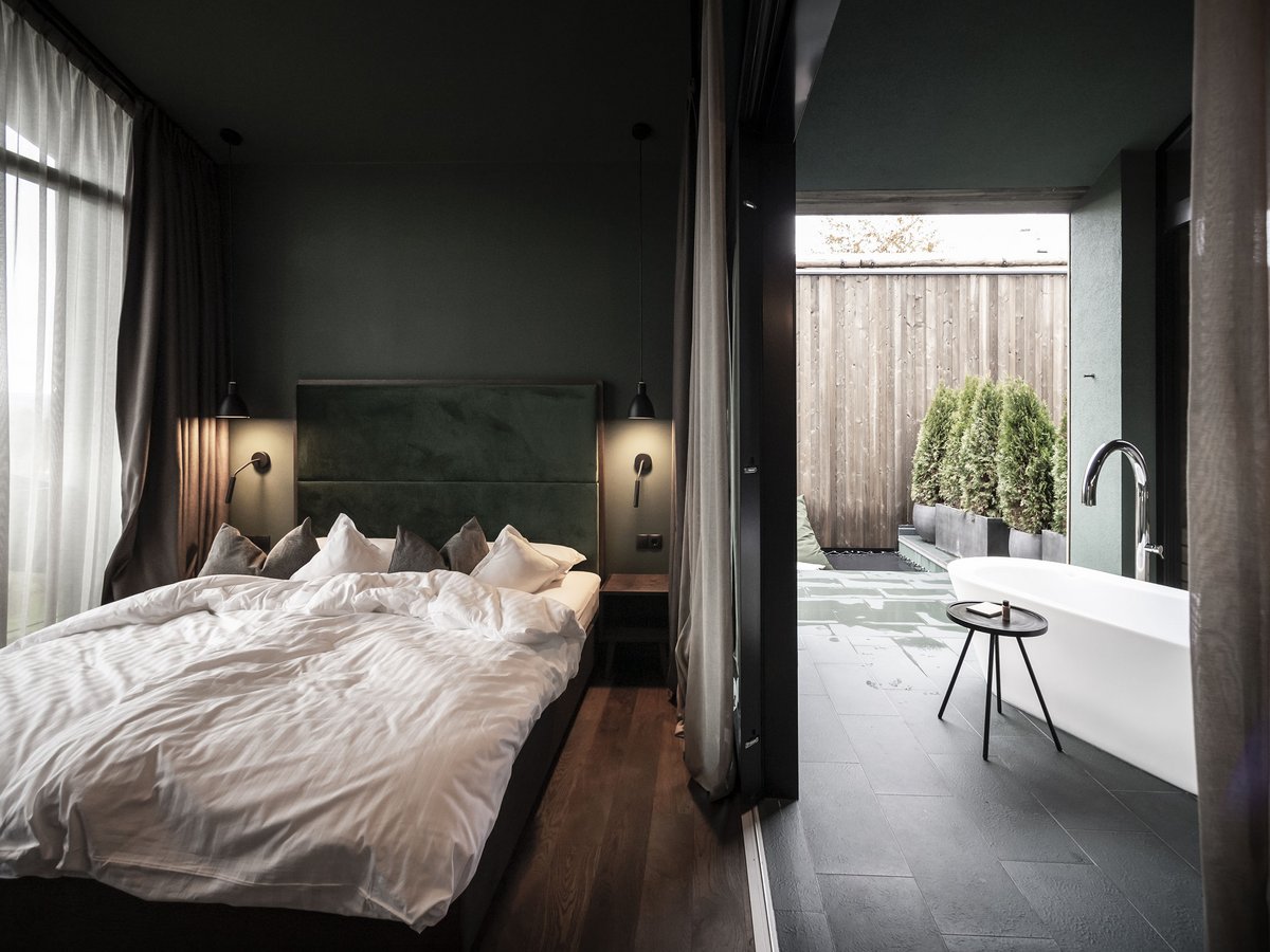 Chalet-Schlafzimmer mit Zugang zur Außenbadewanne und Terrasse Chalet-Schlafzimmer mit Außenbadewanne